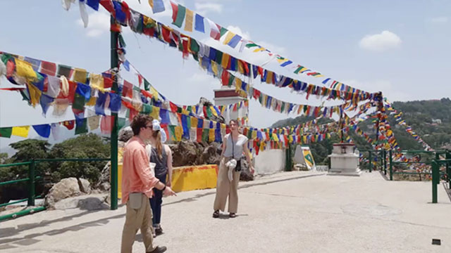 Tourist from different cultures on top of a mountain together